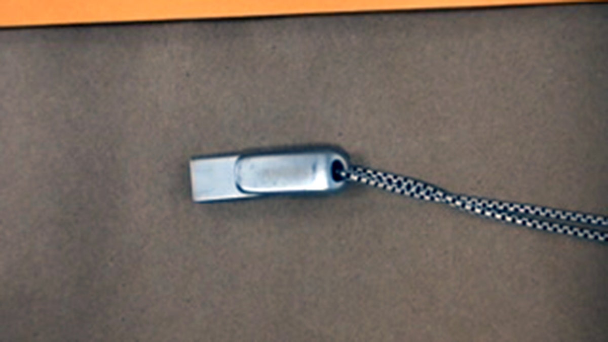 a silver USB drive on a chain