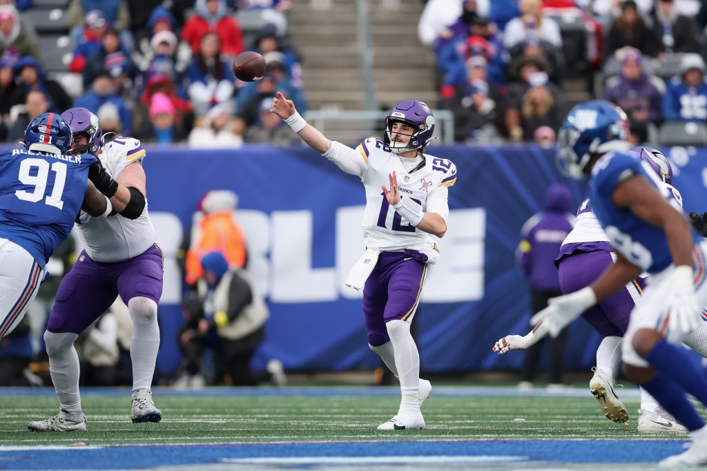 Max Brosmer #12 of the Minnesota Vikings throws a pass during a game against the New York Giants.