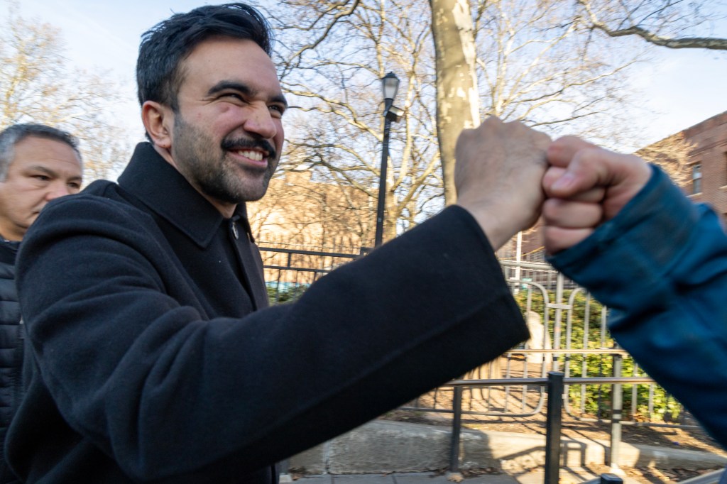 Zohran Mamdani fist-bumping a supporter.