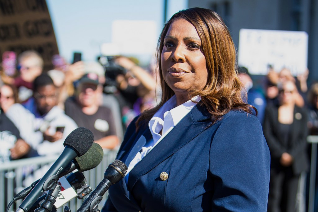 New York Attorney General Letitia James speaking at a podium with microphones.