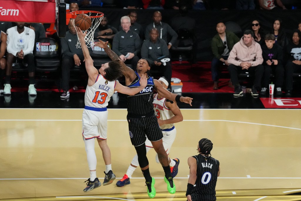 New York Knicks guard Tyler Kolek (13) shoots over Orlando Magic forward Paolo Banchero (5).