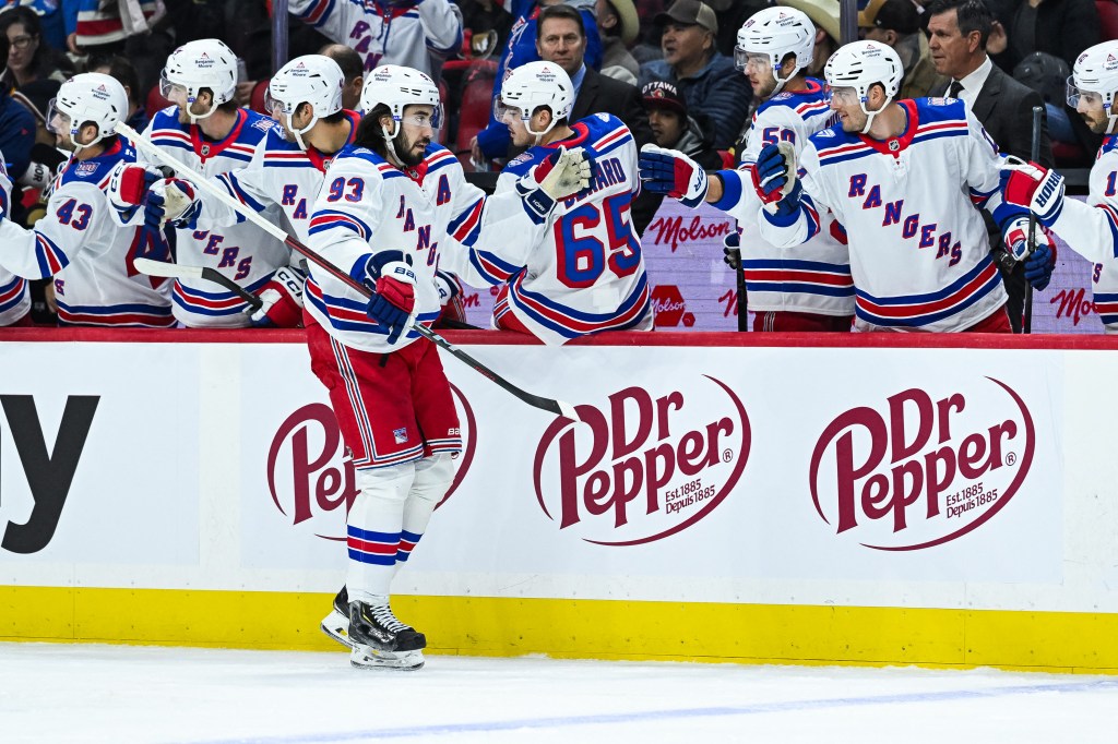 New York Rangers center Mika Zibanejad (93) celebrates a goal with teammates at the bench.