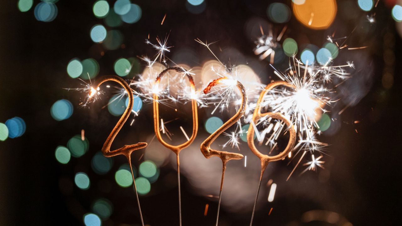 sparklers in the shape of the number 2026, lit up against a dark background