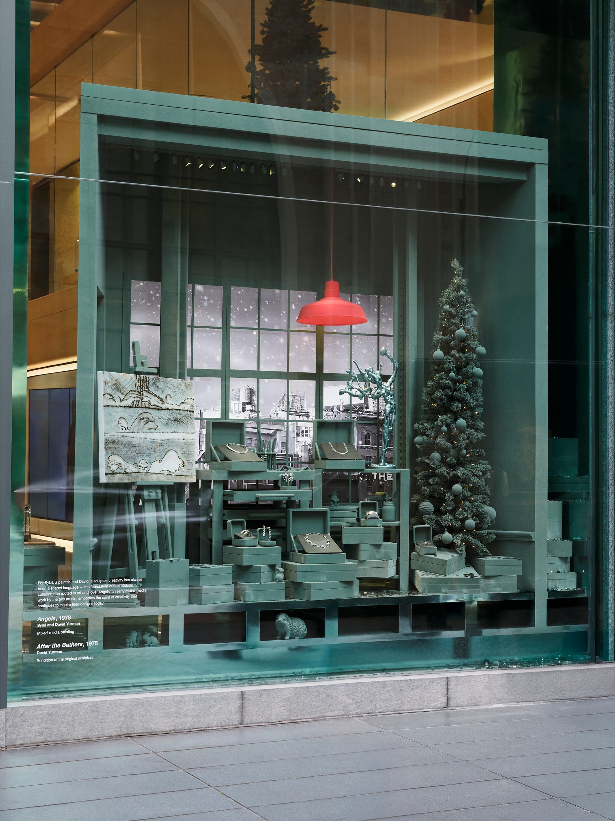 display window featuring a holiday themed setup with art and jewelry