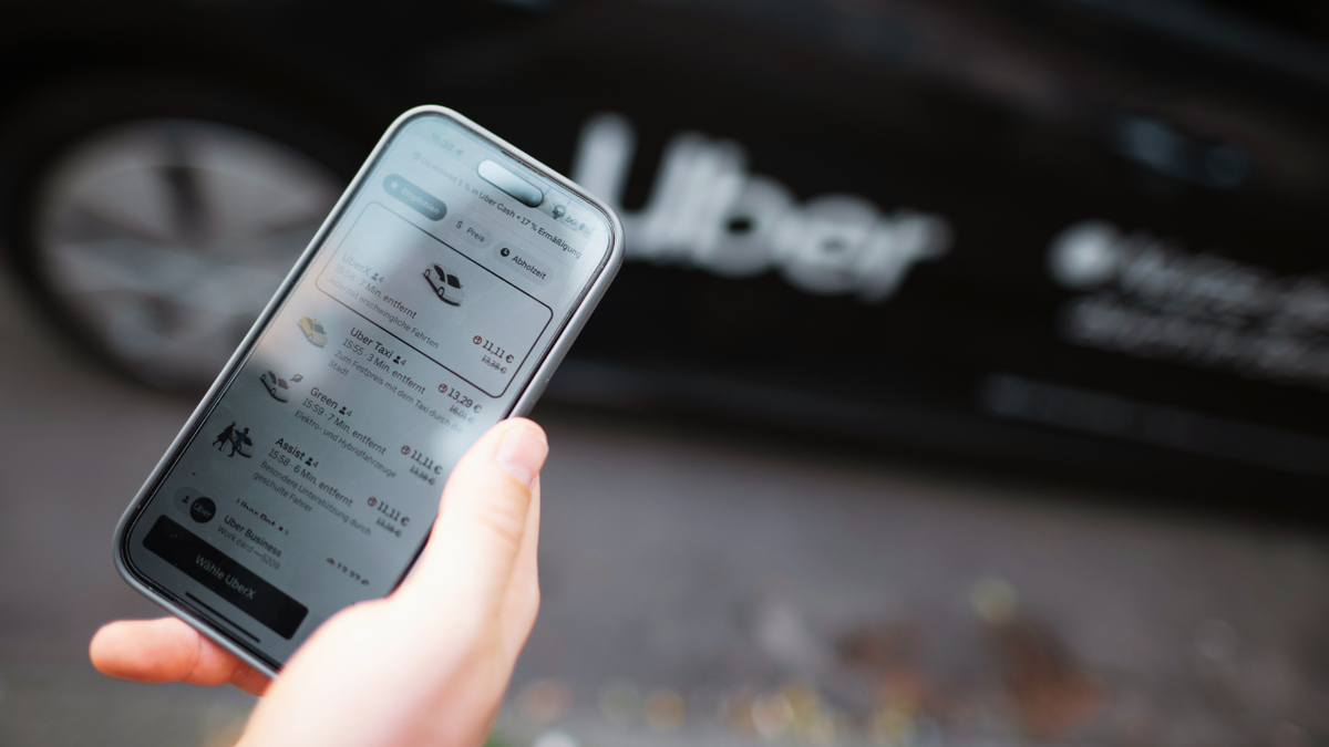 A person orders an Uber ride from the app on their phone.