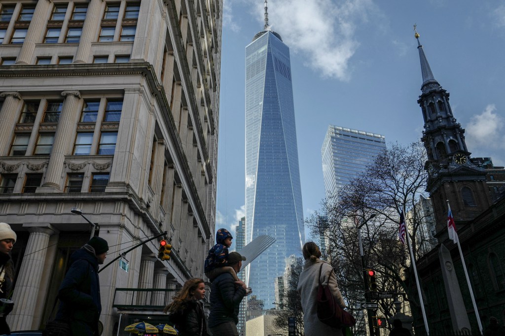People walk near the World Trade Center in New York City.
