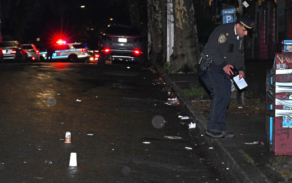 NYPD officer investigating a crime scene on East 16th Street and Avenue J in Midwood, Brooklyn.