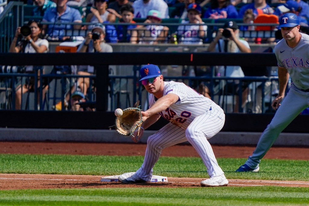 Pete Alonso of the New York Mets catches the ball for an out against the Texas Rangers.