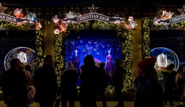 Shoppers and pedestrians walk past a window display at Saks Fifth Avenue in New York, Dec. 14, 2023. (AP Photo/Peter K. Afriyie, File)