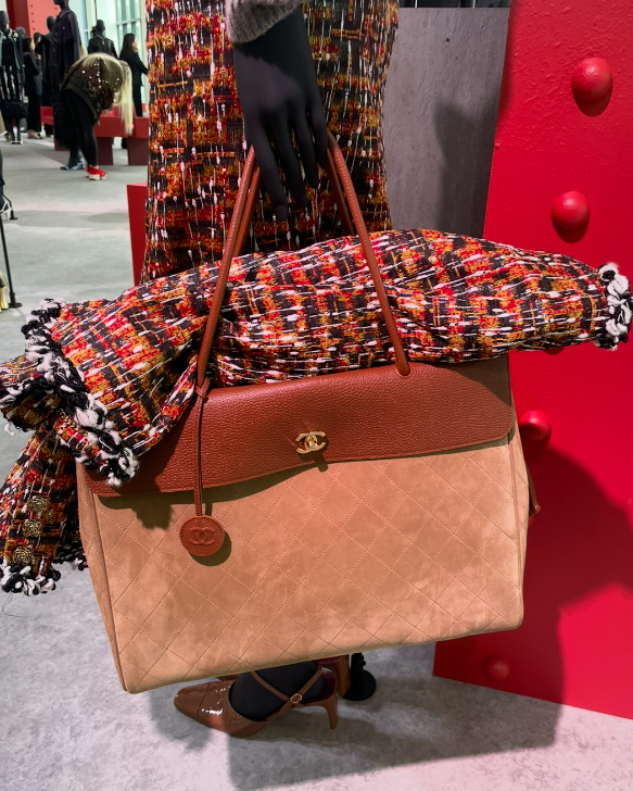 chanel handbag with a colorful scarf displayed on a mannequin