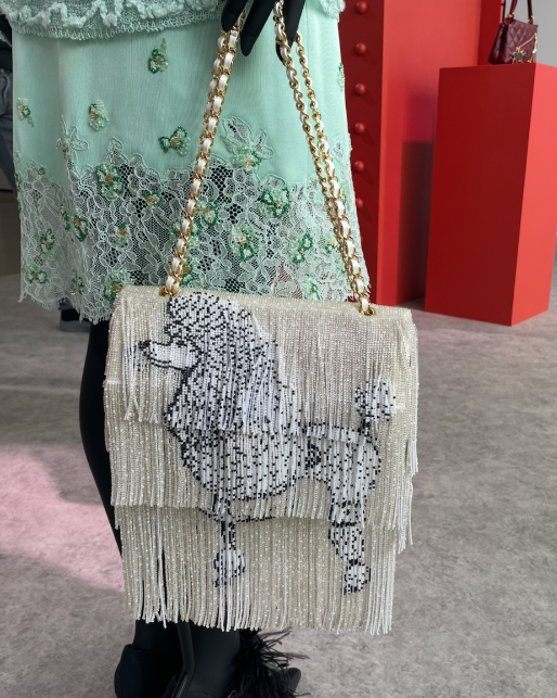 handbag featuring a poodle design made of beads and fringes