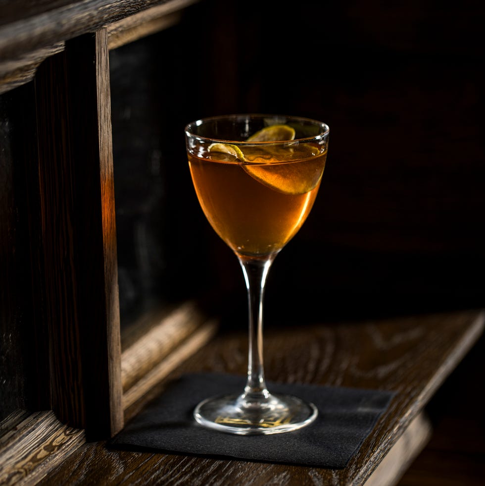 cocktail served in a stemmed glass on a wooden surface