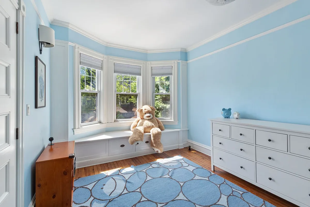 bedroom with window seat, picture rails, blue walls