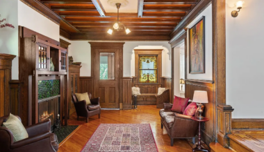 foyer with arts and crafts mantel, beamed ceiling, wainscoting