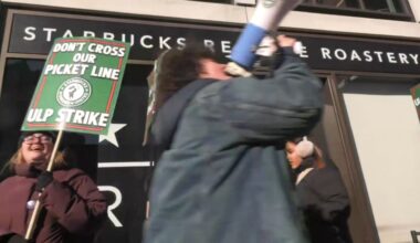 Starbucks employees and supporters picket outside the Starbucks Reserve Roastery in Chelsea on Wednesday, Dec. 24, 2025. (Spectrum News NY1)