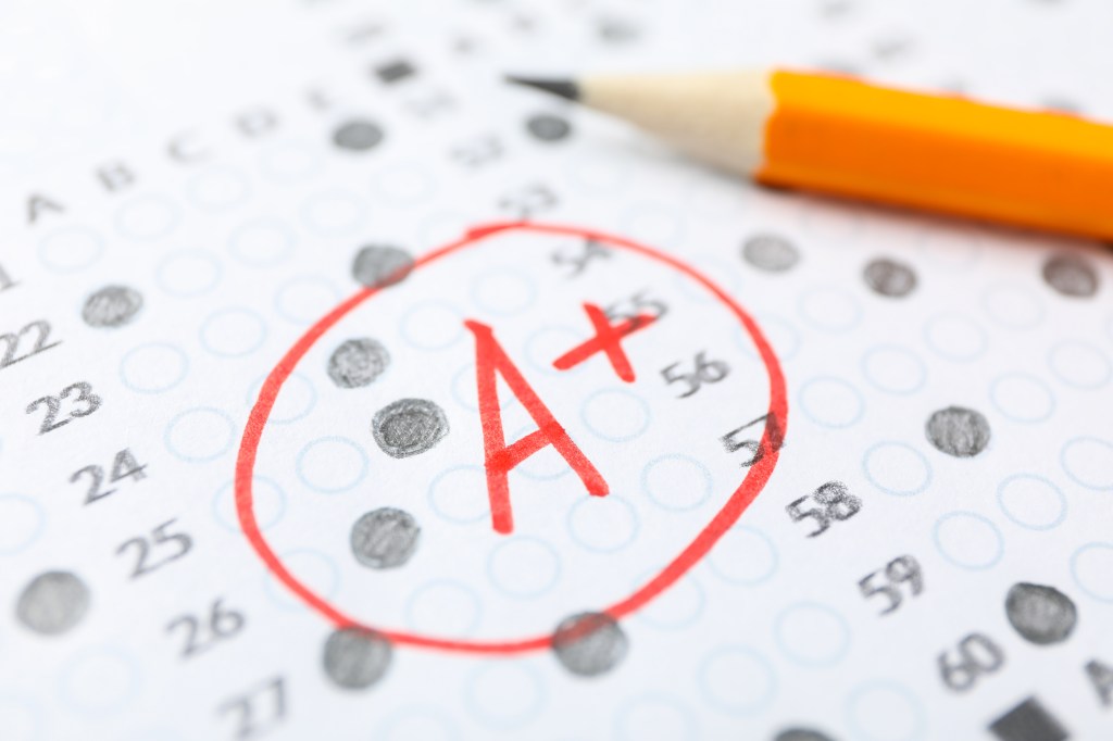 Test score sheet with an A+ grade circled in red and a pencil.