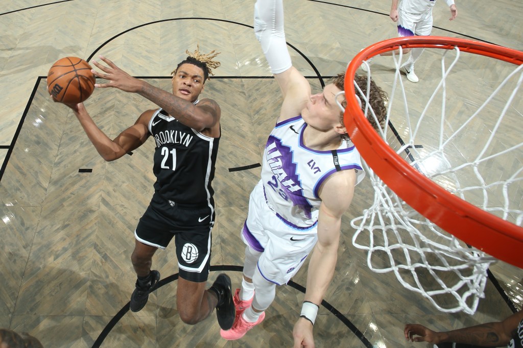 Noah Clowney of the Brooklyn Nets drives to the basket as Lauri Markkanen of the Utah Jazz plays defense.