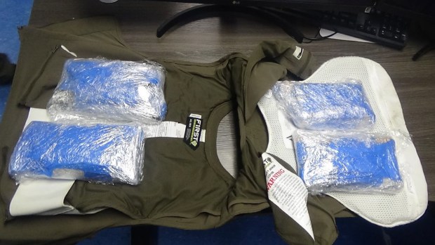 Authorities found vacuum-sealed bags, three with cigarettes, the fourth with pot, hidden inside a vest being worn by Najee Jackson, a correction officer at the Metropolitan Detention Center in Brooklyn, officials said. (United States District Court)