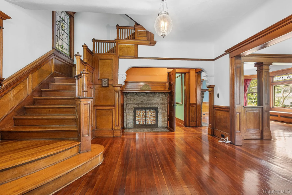 a wood-filled entry hall with a mantel