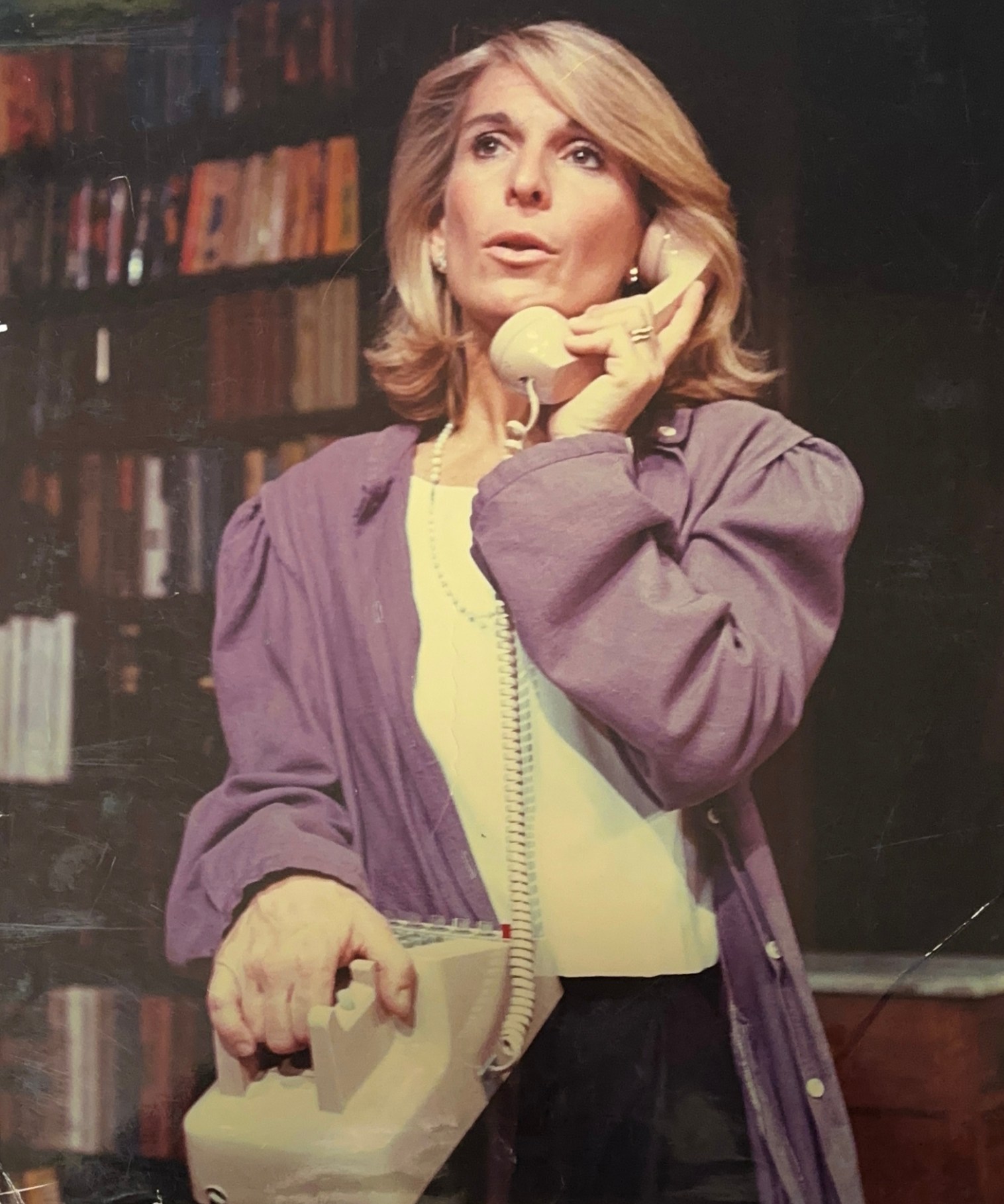 Archive photo of a woman portraying a role in the off-Broadway play "Perfect Crime," holding a landline phone to her ear.