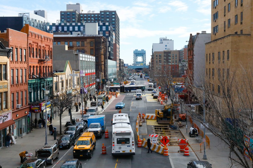 An MTA bus heads east on 125h Street,
