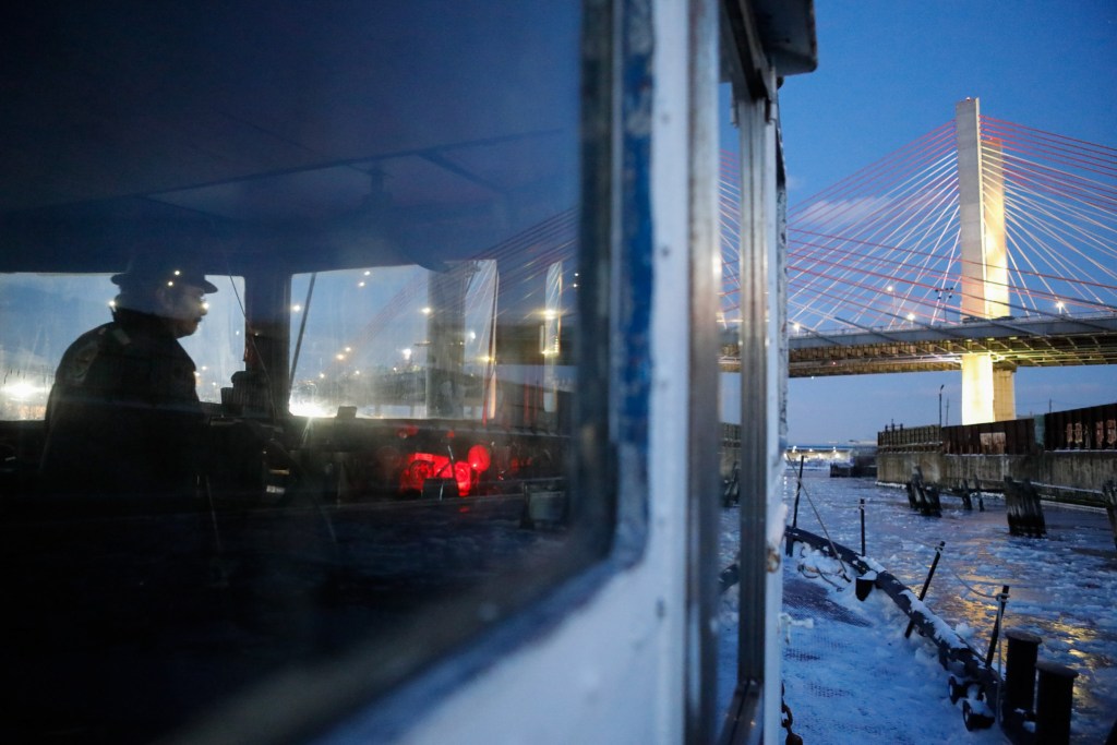 N.D. Austin steers a tugboat up Newtown Creek to help break up ice