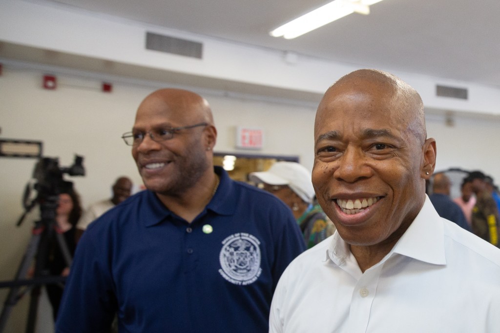 Mayoral aide Tony Herbert, left, joins Eric Adams at the opening of a Brownsville, Brooklyn recreation center.