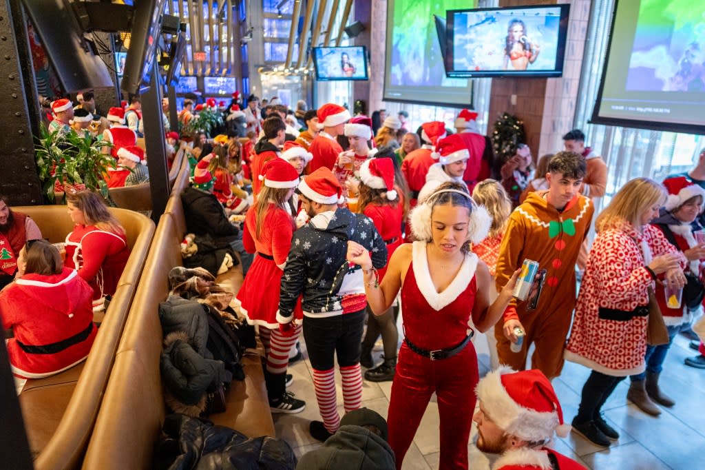 Revelers drink and dance in Yard House wearing holiday character costumes during the SantaCon bar crawl on December 13, 2025 in New York City. Getty Images