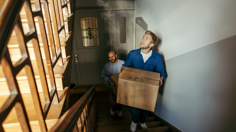 Man moving into a walk-up apartment