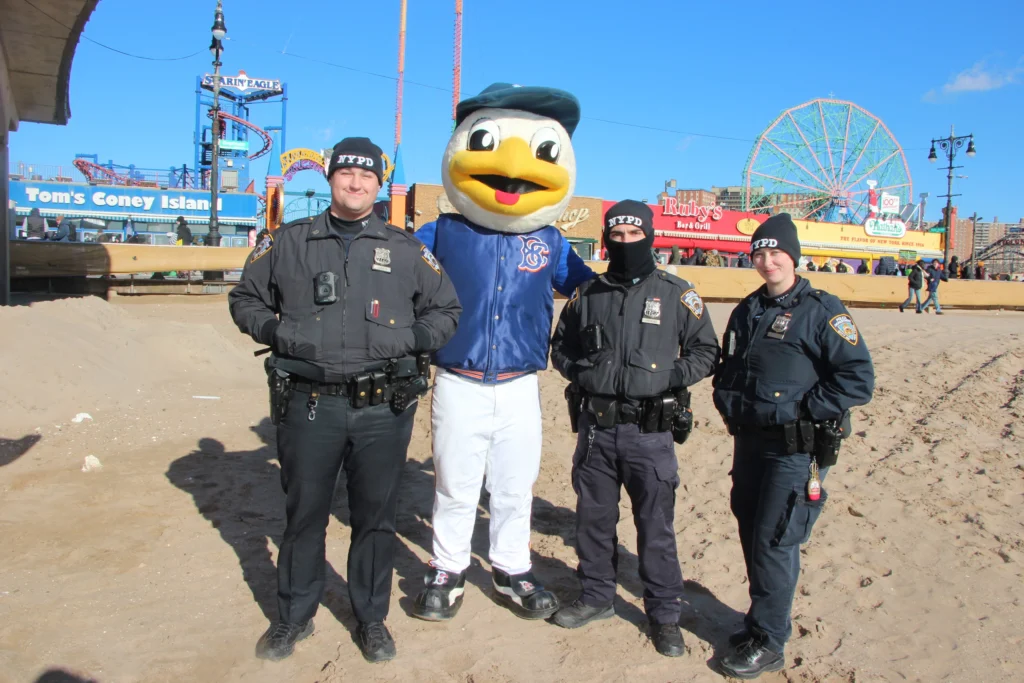NYPD officers alongside Brooklyn Cyclones Mascot Sandy the Seagull. Brooklyn Eagle photo by Mario Belluomo