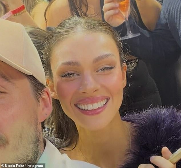 Nicola Peltz appeared to be showing off updated teeth and lip filler according to experts as she posed with husband Brooklyn on NYE