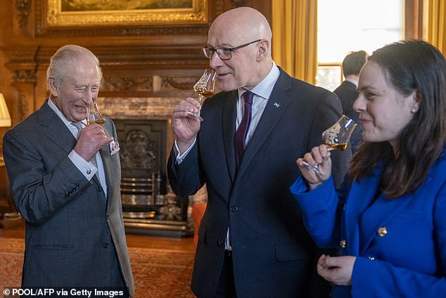 King Charles, Deputy First Minister Kate Forbes (R) and First Minister of Scotland John Swinney (C) sample whisky at the Palace of Holyroodhouse in Edinburgh