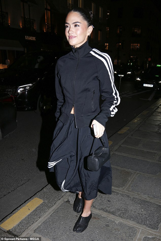 She completed the look with black Tabi ballerina flats, toting her essentials in a mini black bag