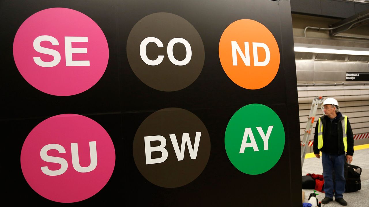 Workers put the finishing touches on the new 86th Street subway station in New York on Thursday, Dec. 22, 2016. (AP Photo/Seth Wenig)