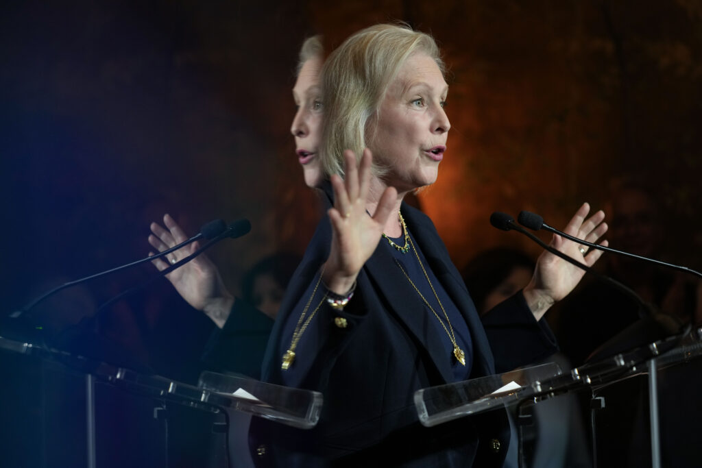 Sen. Kirsten Gillibrand, D-N.Y, is reflected on a television screen as she speaks in New York, Tuesday, Nov. 5, 2024. (AP Photo/Seth Wenig)