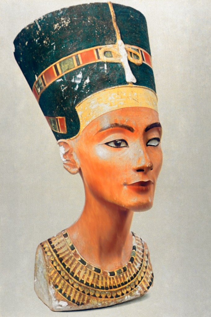 Bust of Queen Nefertiti with a tall, blue headdress and a detailed collar.