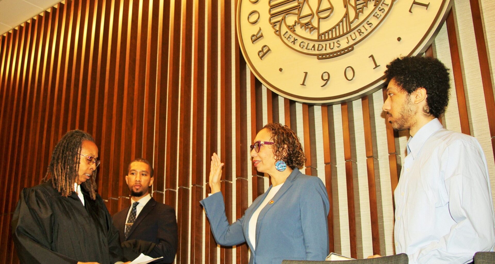Hon. Juliet Howard being sworn in by Hon. Norma Jennings alongside their sons. Brooklyn Eagle photo by Mario Belluomo