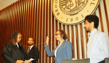 Hon. Juliet Howard being sworn in by Hon. Norma Jennings alongside their sons. Brooklyn Eagle photo by Mario Belluomo