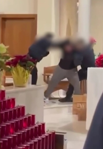 Police fight with a disruptive man at St. Ann Catholic Church in New York, New York, during a Friday morning mass in January 2026. 