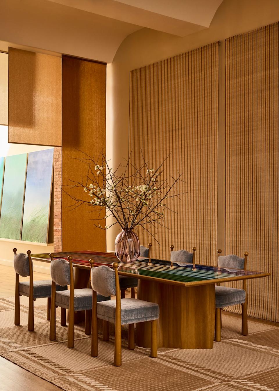 Dining area featuring a colorful table and decorative vase.