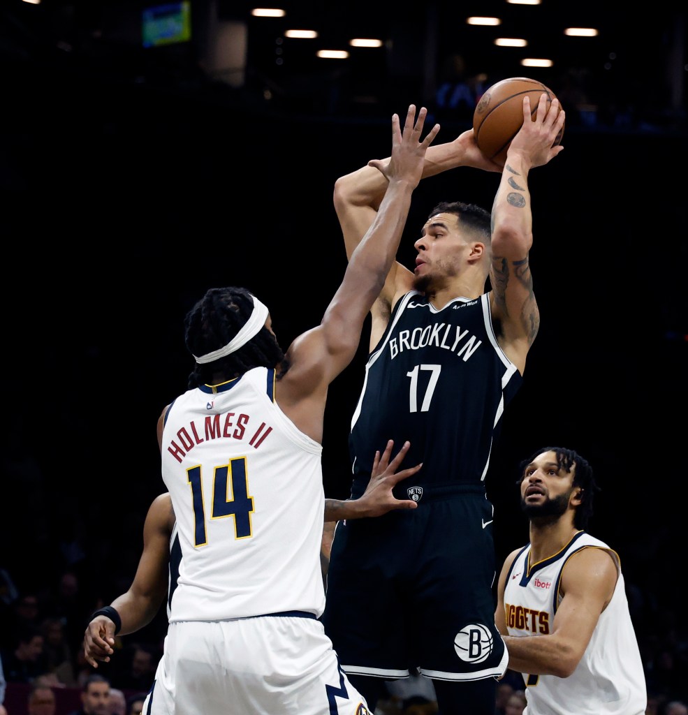 Michael Porter Jr. #17 of the Brooklyn Nets looks for the open man as Daron Holmes II #14 of the Denver Nuggets defends in the second half. The Brooklyn Nets defeat the Denver Nuggets at the Barclays Center in Brooklyn, New York, Sunday, January 04, 2026. 