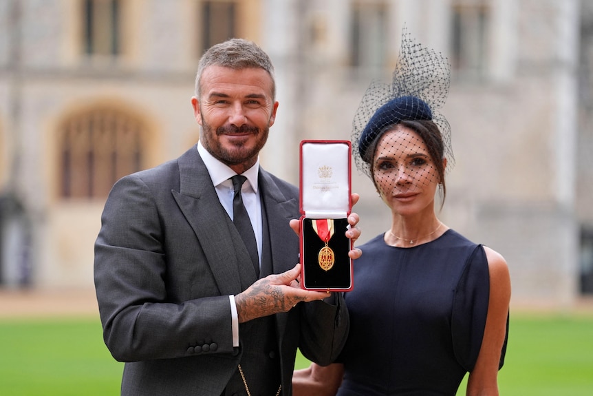 Brooklyn's parents, David Beckham, who is holding a medal, and Victoria Beckham. 