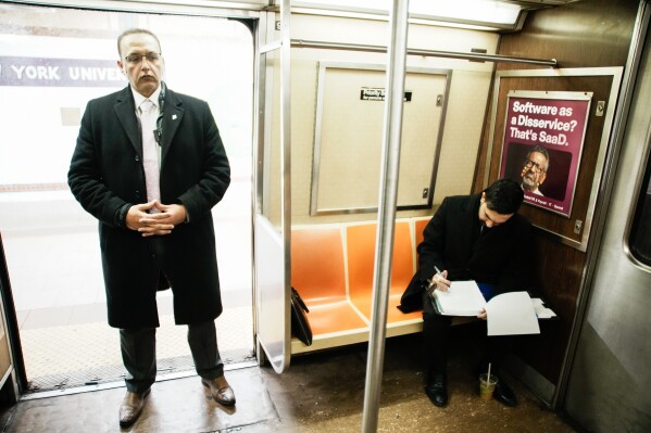 New York City Mayor Zohran Mamdani checks his agenda on the subway on his way to City Hall in New York, Friday, Jan. 2, 2026. (AP Photo/Eduardo Munoz Alvarez)