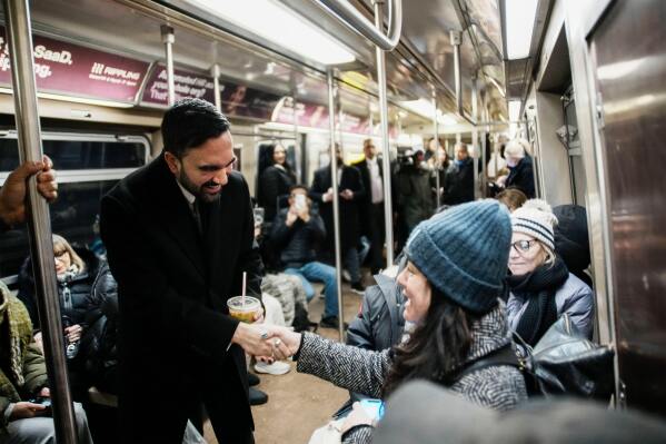 New York City Mayor Zohran Mamdani greets passengers on a subway to City Hall in New York, Friday, Jan. 2, 2026. (AP Photo/Eduardo Munoz Alvarez)