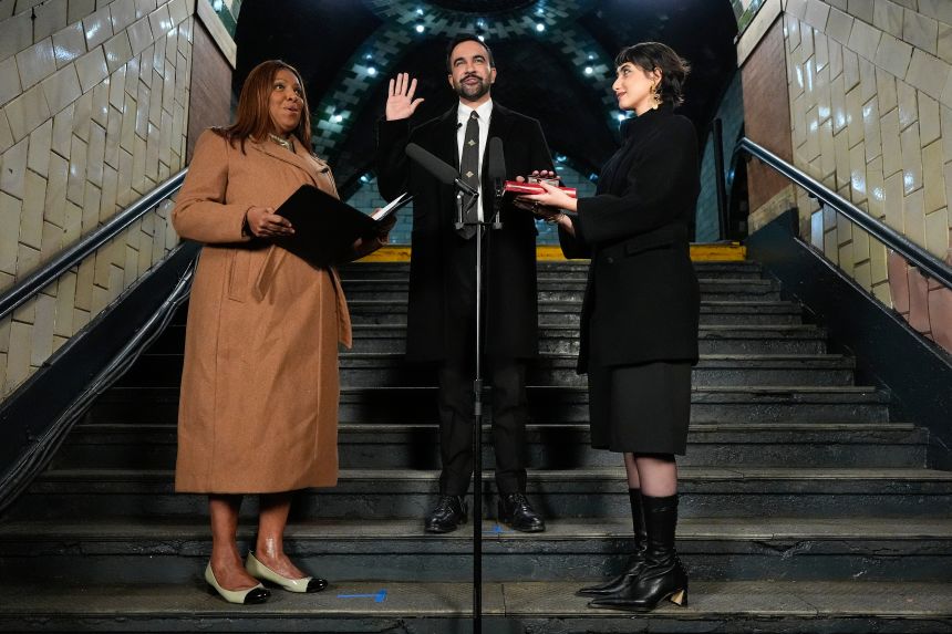 New York Attorney General Letitia James, left, administers the oath of office to mayor-elect Zohran Mamdani, center, as his wife Rama Duwaji looks on, on January 1.