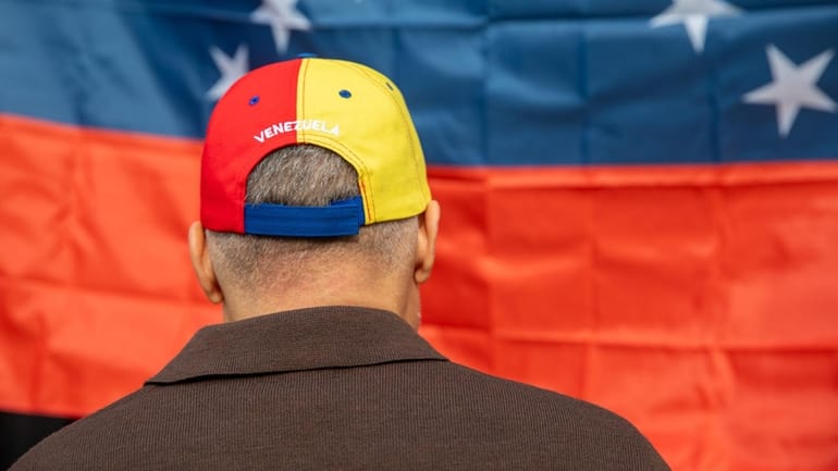 Riccardo Romero, of Merrick, wears a Venezuela hat at Arepa Cafe...