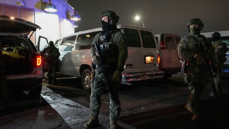 Federal law enforcement personnel patrol outside the Metropolitan Detention Center...