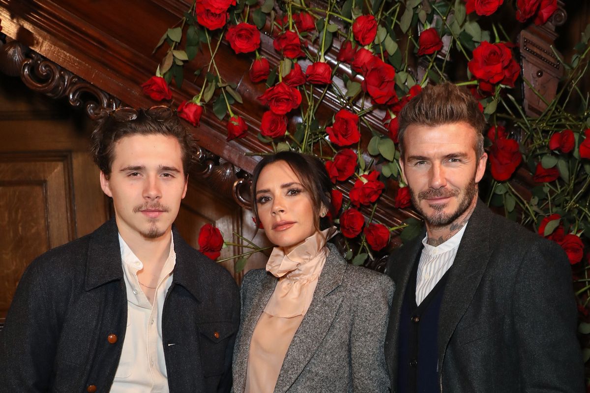 Brooklyn Beckham with his parents David and Victoria 