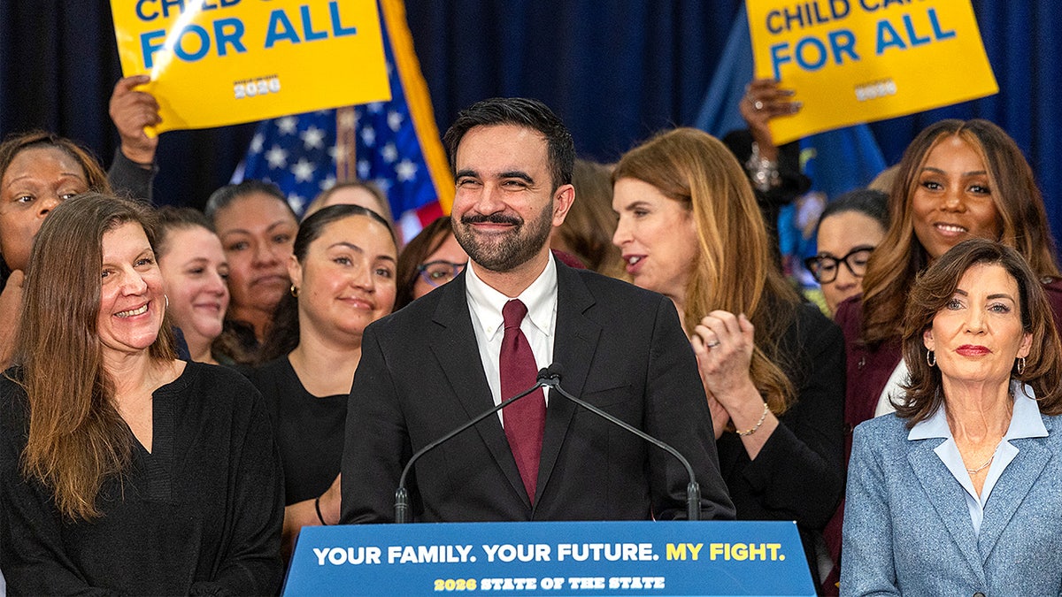 New York City Mayor Zohran Mamdani speaks at a podium while addressing an audience indoors.