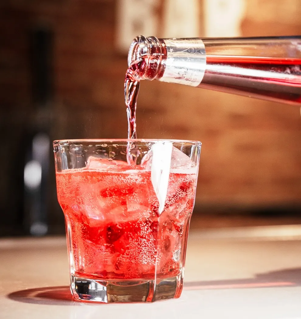 Phony Negroni being poured into a rock glass